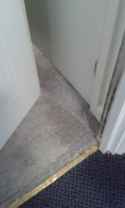 Carpet obstructing fire door