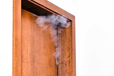 Smoke coming out of a door.